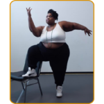 image of Ifasina Clear, a fat, Black person, in a dance pose using a chair.